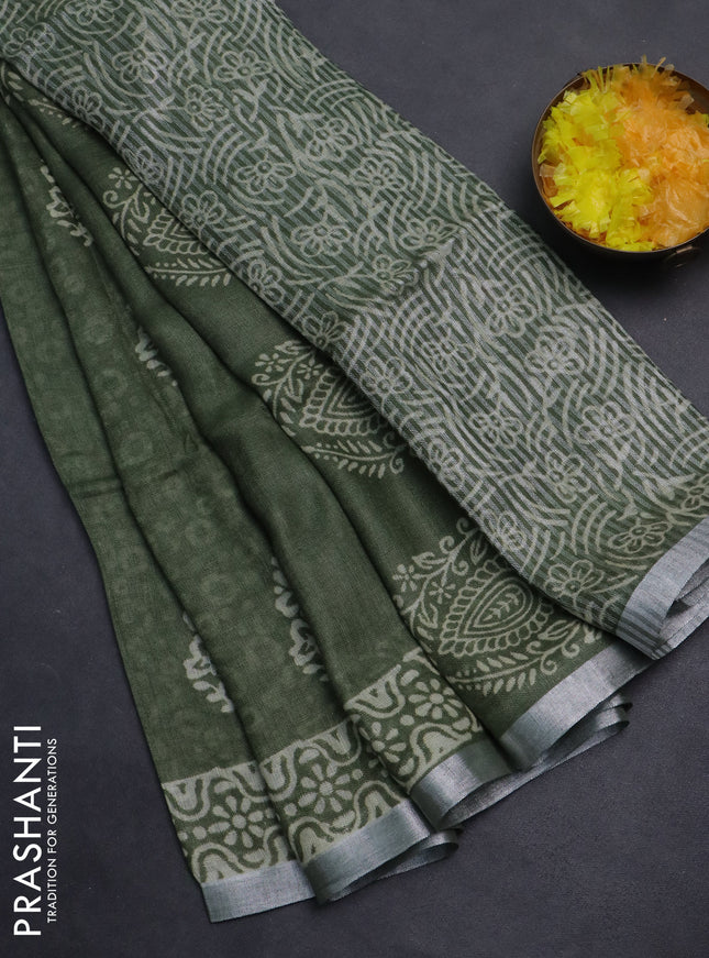 Pure linen saree sap green with allover butta prints and silver zari woven border