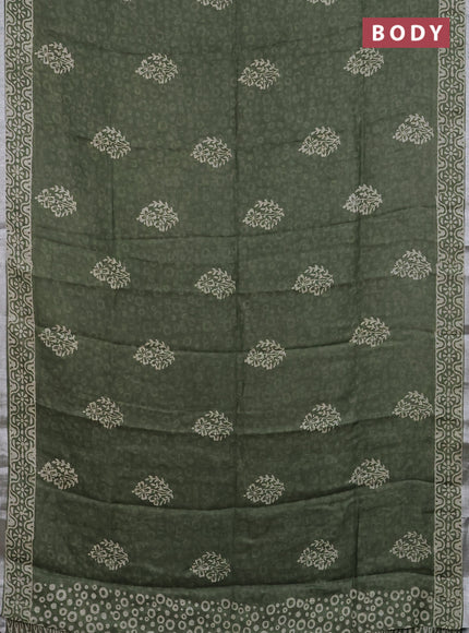 Pure linen saree sap green with allover butta prints and silver zari woven border