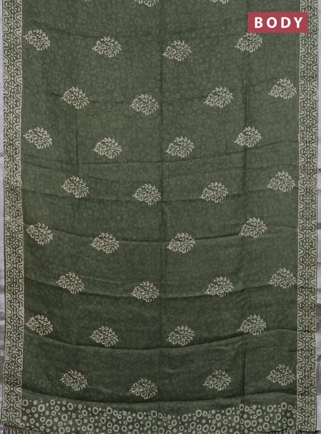 Pure linen saree sap green with allover butta prints and silver zari woven border