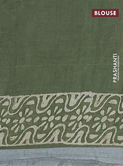 Pure linen saree sap green with allover butta prints and silver zari woven border