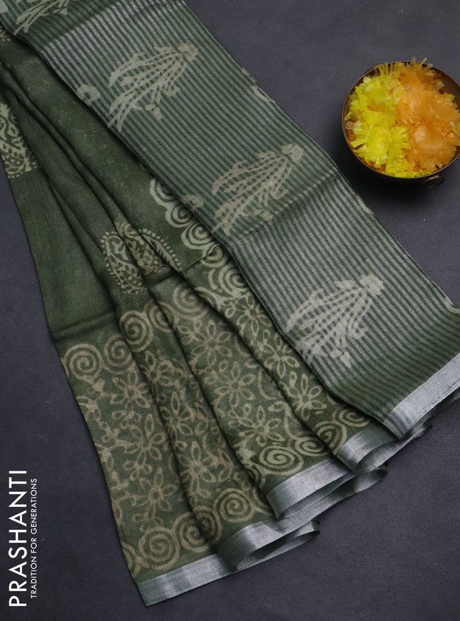 Pure linen saree sap green with allover butta prints and silver zari woven border
