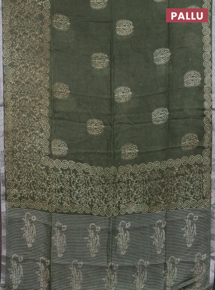 Pure linen saree sap green with allover butta prints and silver zari woven border