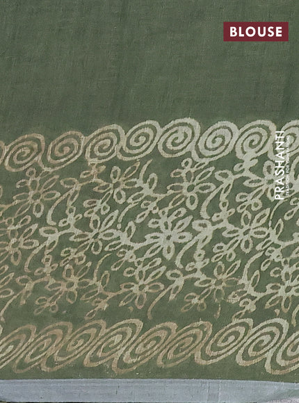 Pure linen saree sap green with allover butta prints and silver zari woven border