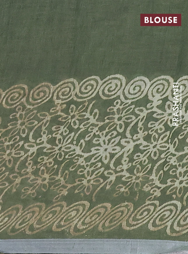 Pure linen saree sap green with allover butta prints and silver zari woven border