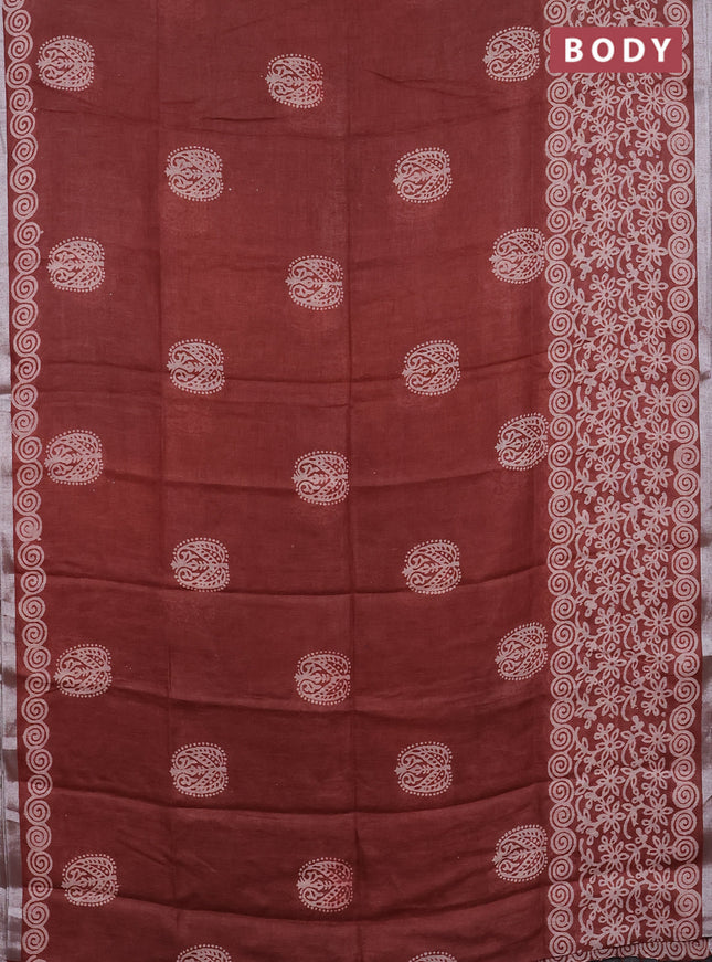 Pure linen saree rust shade with allover butta prints and silver zari woven border