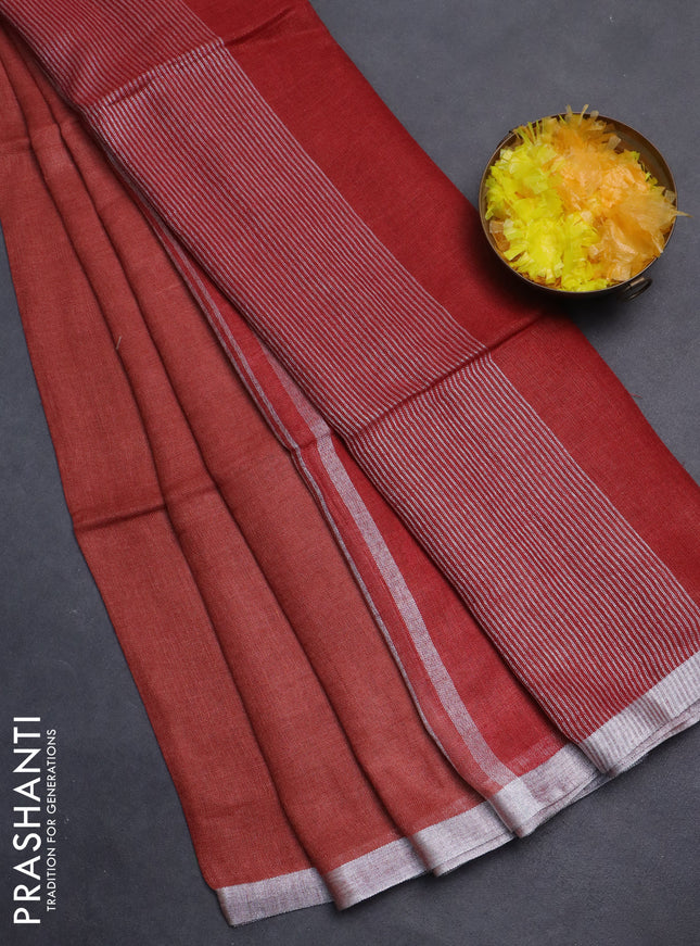 Pure linen saree rust shade and maroon with plain body and silver zari woven border