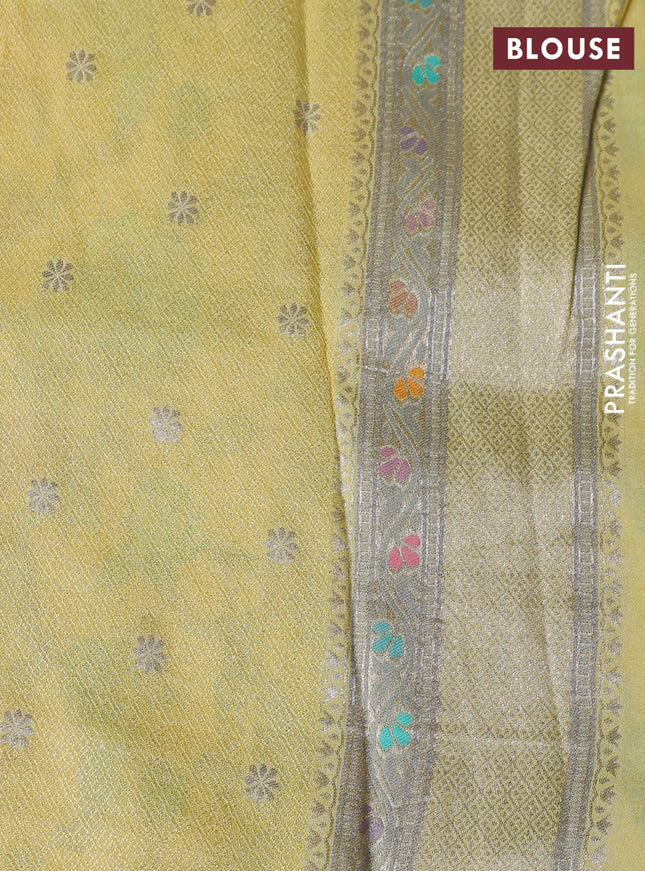 Banarasi tissue silk saree pale yellow with allover thread woven floral weaves and silver zari woven border