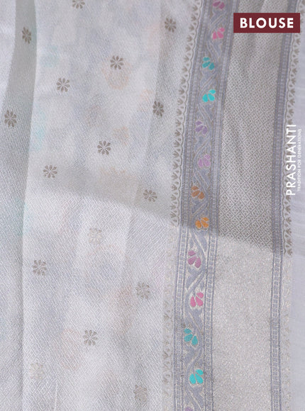 Banarasi tissue silk saree off white with allover thread woven floral weaves and silver zari woven border