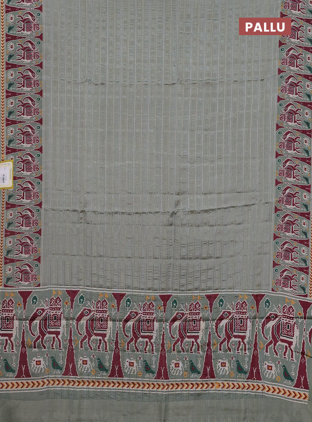 Semi tussar saree pastel green with zari stripes pattern and patola printed border