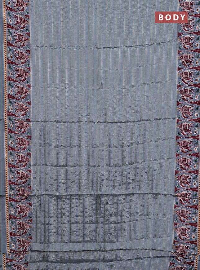 Semi tussar saree pastel grey with zari stripes pattern and patola printed border
