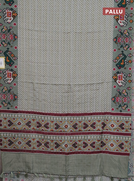 Semi tussar saree pastel green with leheriya prints and patola printed border