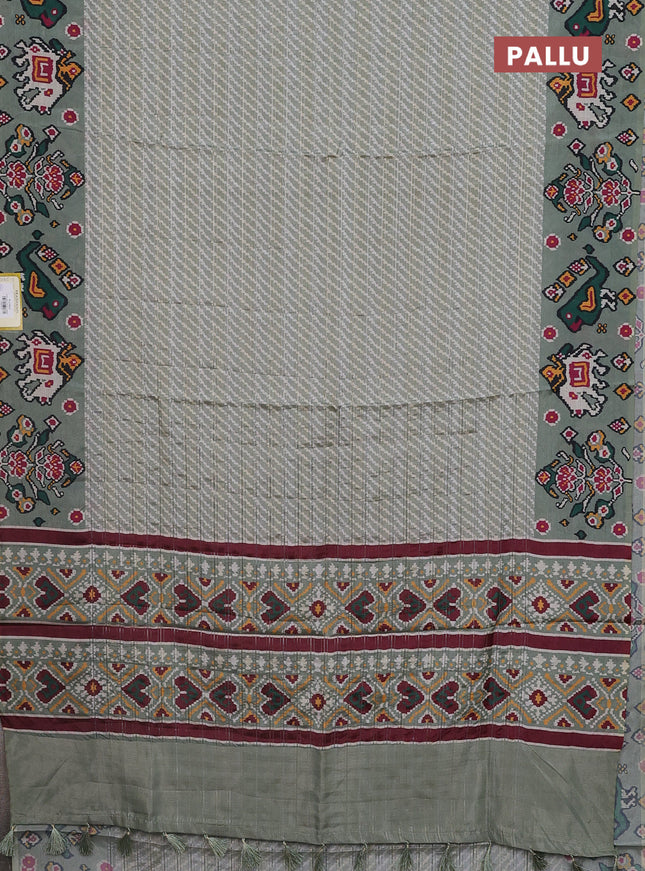 Semi tussar saree pastel green with leheriya prints and patola printed border