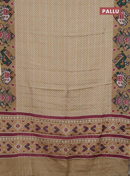 Semi tussar saree mustard shade with leheriya prints and patola printed border