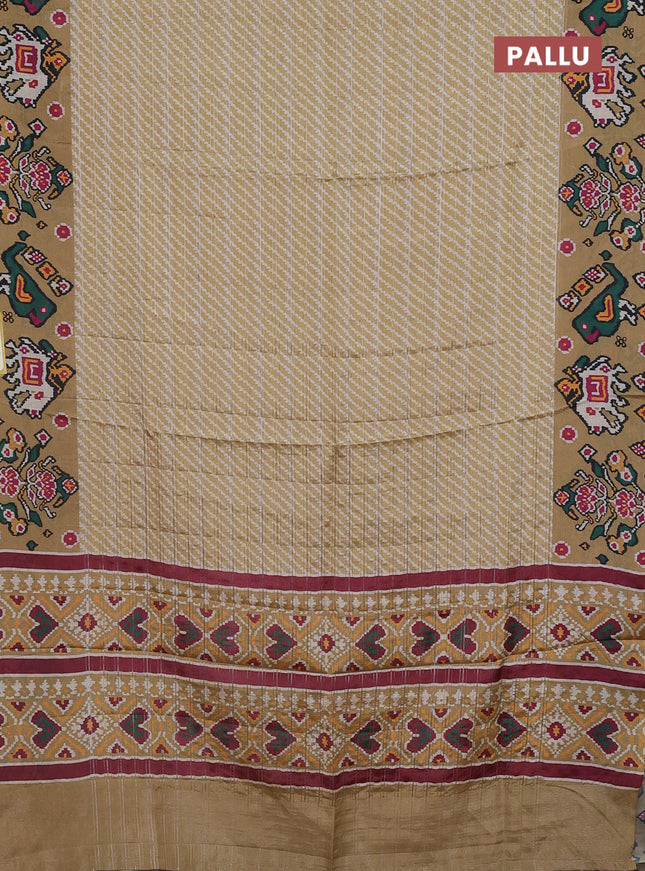 Semi tussar saree mustard shade with leheriya prints and patola printed border