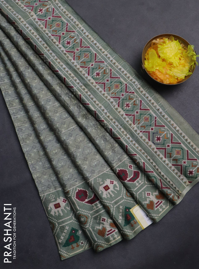 Semi tussar saree pastel green with zari stripes pattern and patola printed border