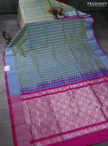 Pure uppada silk saree dual shade of teal blue and pink with allover silver zari woven buttas and zari woven border