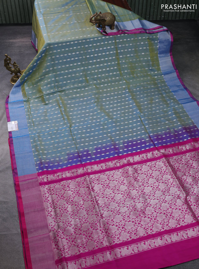 Pure uppada silk saree dual shade of teal blue and pink with allover silver zari woven buttas and zari woven border