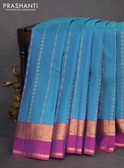 Kanchipuram silk saree dual shade of teal and purple with allover zari weaves and rettapet zari woven border