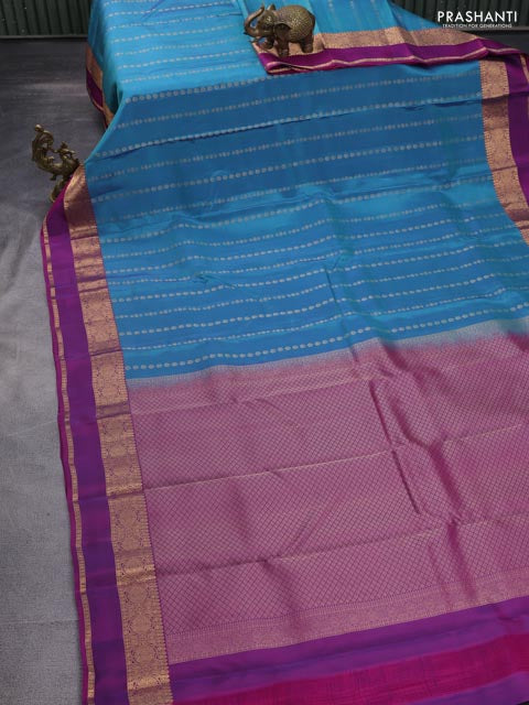 Kanchipuram silk saree dual shade of teal and purple with allover zari weaves and rettapet zari woven border