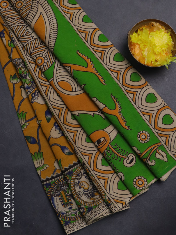 Kalamkari cotton saree mustard yellow and light green with allover prints and printed border
