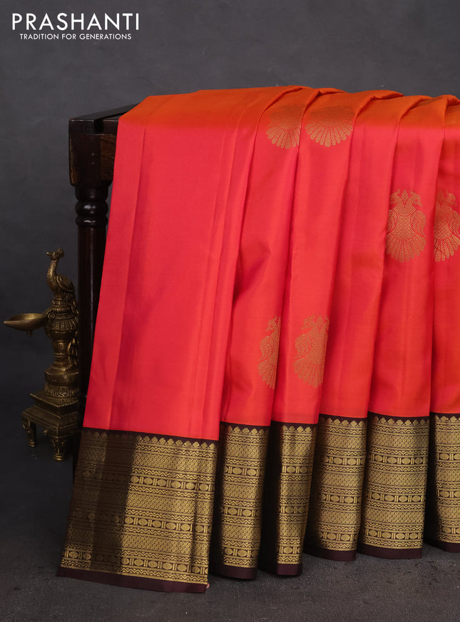 Pure kanchipuram silk saree dual shade of pinkish orange and brown with peacock zari woven buttas and zari woven korvai border