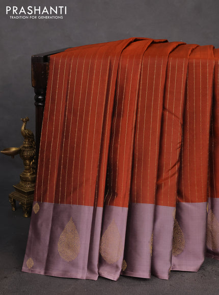 Pure kanchipuram silk saree rust shade with allover zari weaves and zari woven butta border