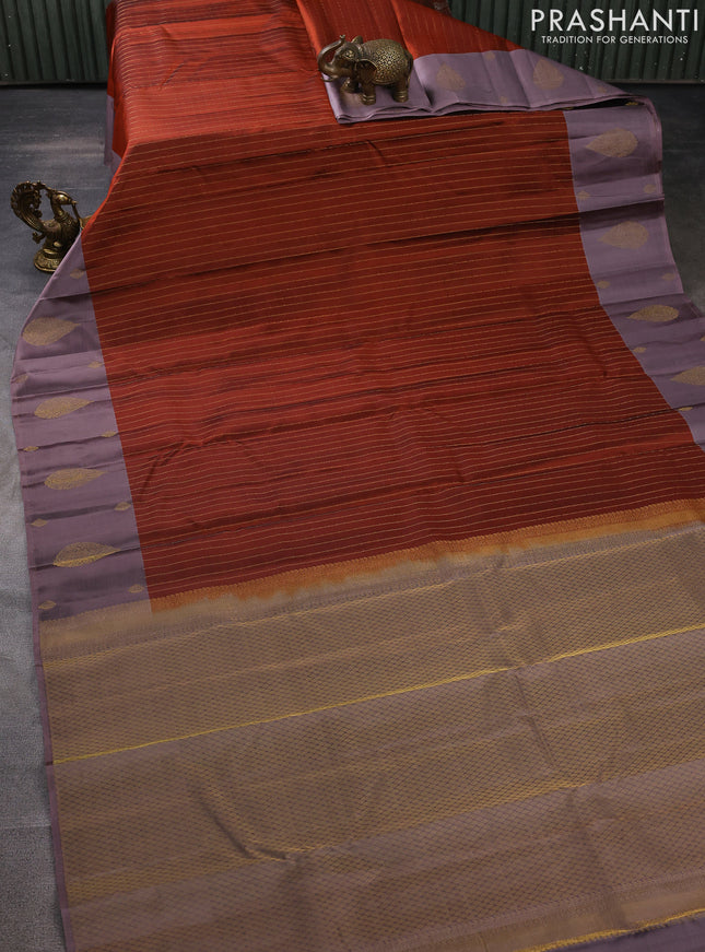 Pure kanchipuram silk saree rust shade with allover zari weaves and zari woven butta border