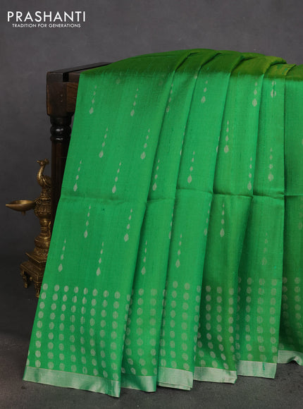 Pure raw silk saree green and pastel peach with allover silver zari woven buttas and silver zari woven border