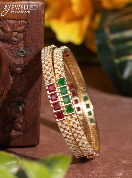 Pearl rajawadi bangles with kemp stones and pearls in gold finish