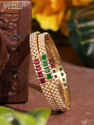 Pearl bangles with kemp stones and pearls in gold finish