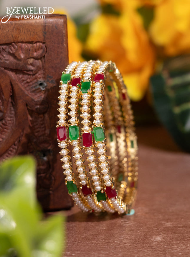 Pearl bangles with kemp stones and pearls in gold finish