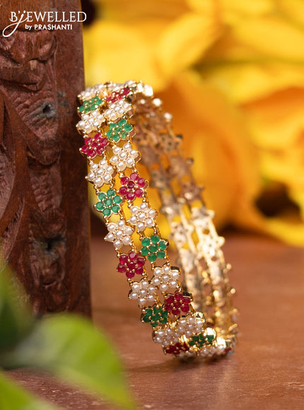 Pearl bangles with kemp stones and pearls in gold finish