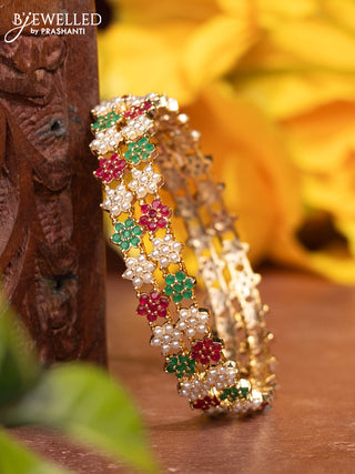 Pearl bangles with kemp stones and pearls in gold finish