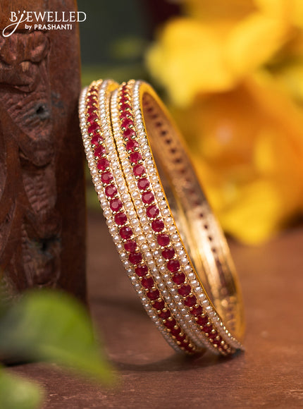 Pearl bangles with ruby stones and pearls in gold finish