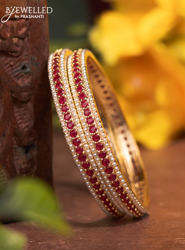 Pearl bangles with ruby stones and pearls in gold finish