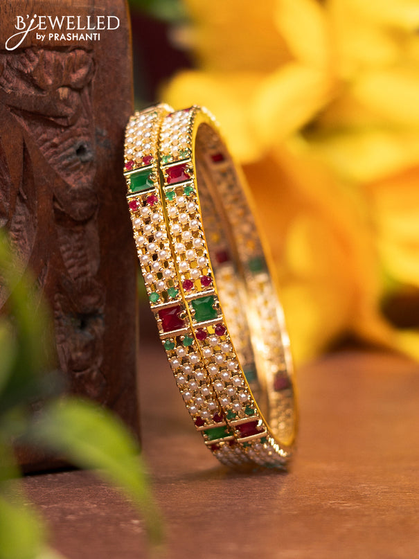 Pearl bangles with kemp stones and pearls in gold finish