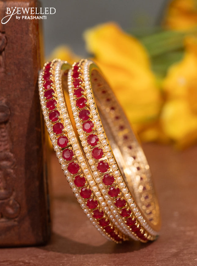 Pearl bangles with ruby stones and pearls in gold finish
