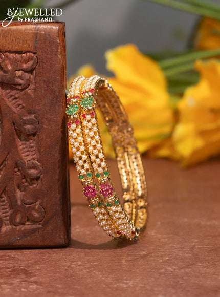 Pearl bangles with kemp stones and pearls in gold finish