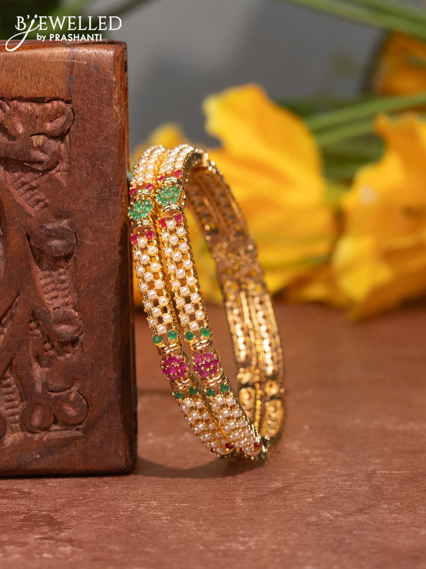 Pearl bangles with kemp stones and pearls in gold finish