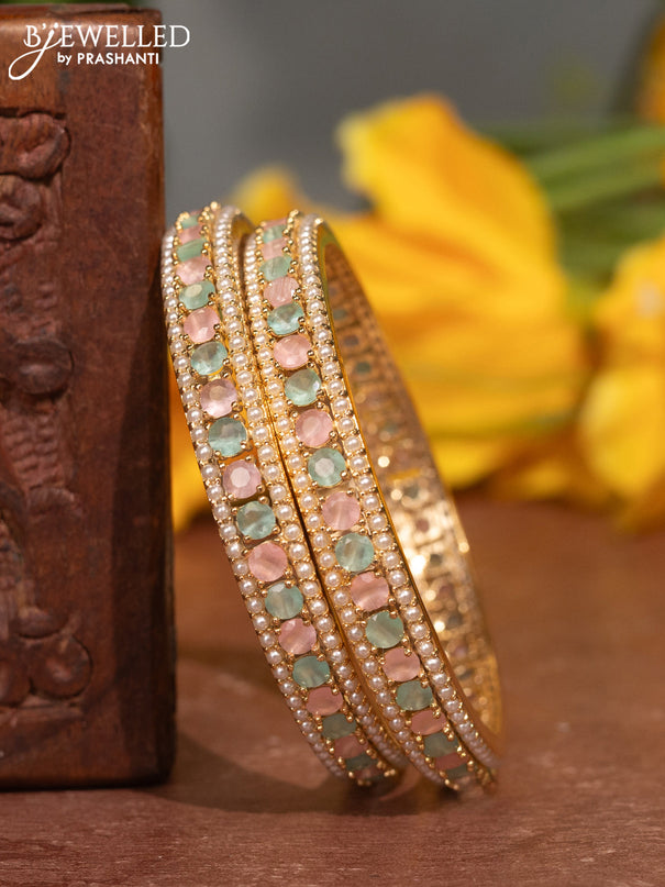 Pearl bangles with baby pink & mint green stones and pearls in gold finish