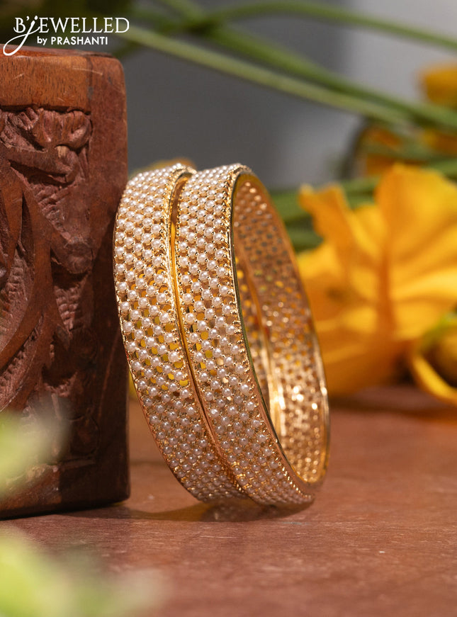 Pearl bangles with and pearls in gold finish