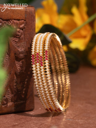 Pearl bangles with ruby stones and pearls in gold finish