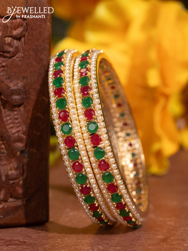 Pearl bangles with kemp stones and pearls in gold finish