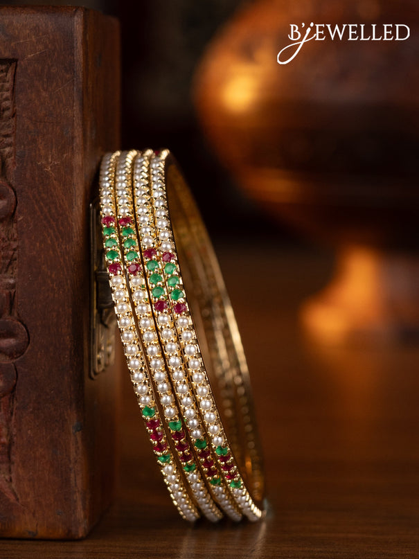 Pearl bangles with kemp stones and pearls in gold finish