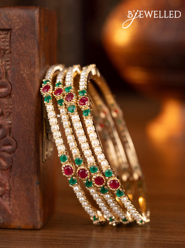 Pearl bangles with kemp stones and pearls in gold finish