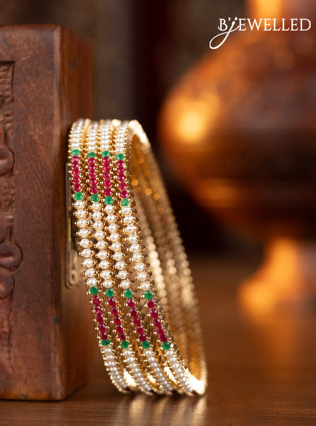 Pearl bangles with kemp stones and pearls in gold finish