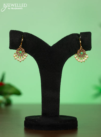 Attigai necklace with floral pendant in kemp ,white and green stones
