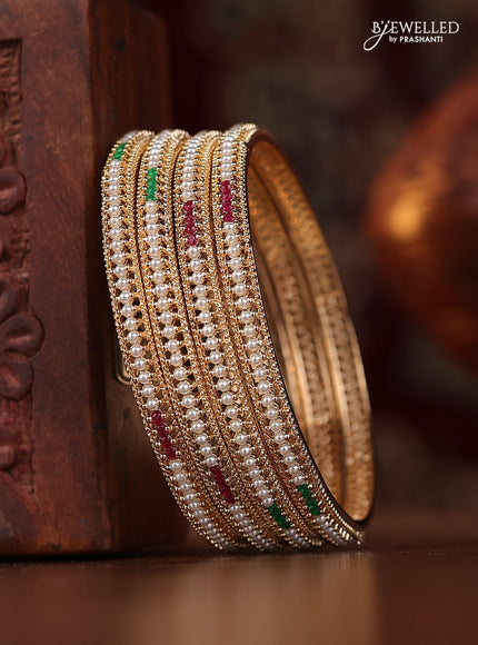 Pearl bangle with kemp stones and pearls in gold finish