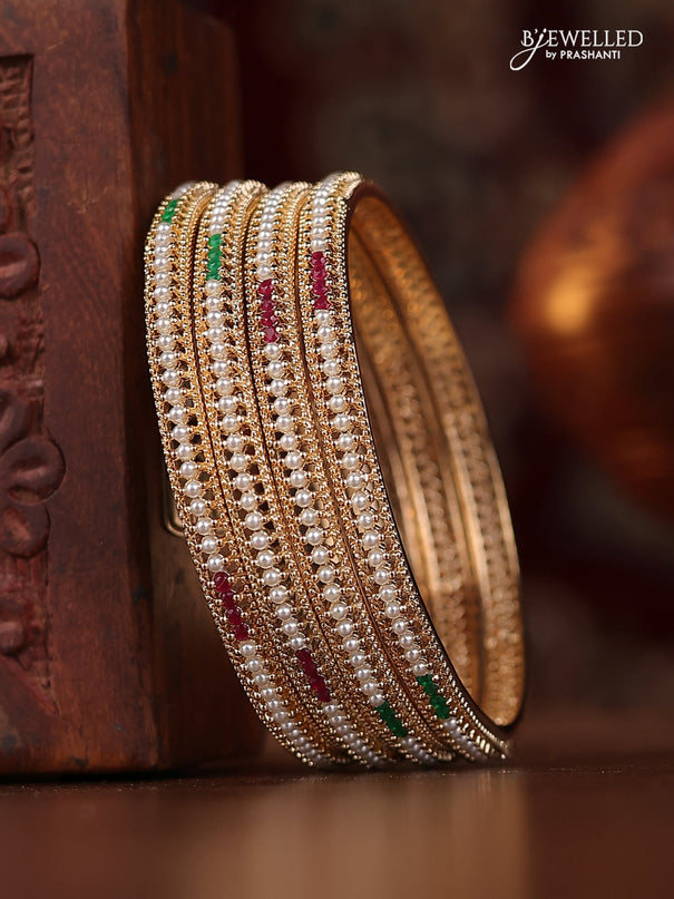Pearl bangle with kemp stones and pearls in gold finish
