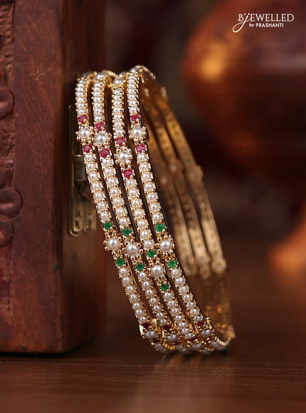 Pearl bangle with kemp stones and pearls in gold finish